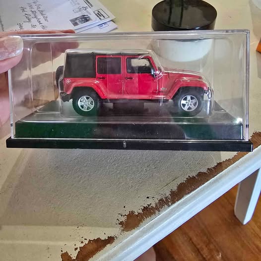 Red diecast truck model in a clear display box