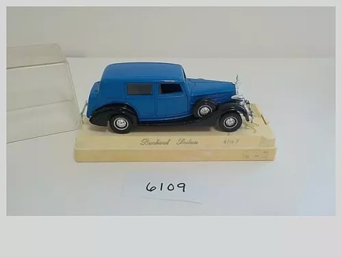 Blue vintage diecast Packard sedan model on display base, marked 6109.