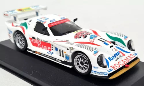 White diecast race car model with red, blue, and yellow racing stripes, front 3/4 view