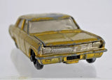 Vintage diecast toy car, olive yellow, front grille and bumper details visible