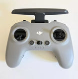 DJI FPV remote controller with dual thumbsticks, buttons, and DJI logo