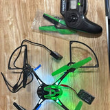 Green micro quadcopter drone with 4 blades, controller, and charging cable