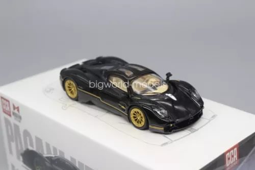 Black diecast sports car model with gold wheels, front three-quarter view.