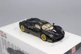 Black diecast sports car model with gold wheels, front three-quarter view.