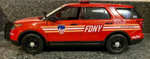 FDNY 2015 Ford Explorer diecast SUV, orange and black with FDNY side graphics