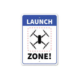 Launch zone metal sign: blue border, “LAUNCH” “ZONE!” and drone icon
