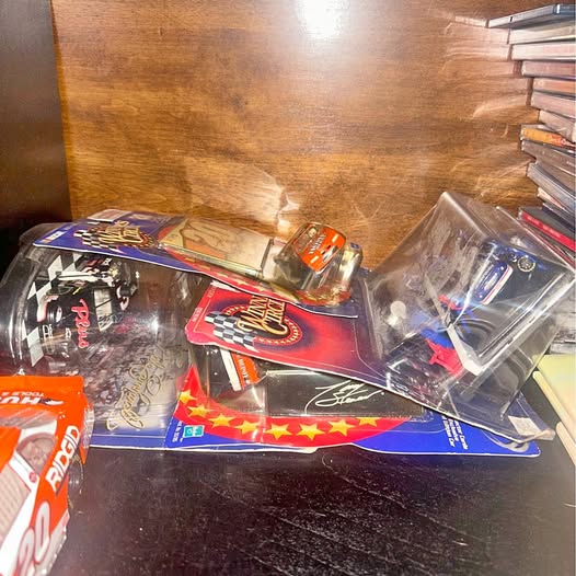 NASCAR diecast car in clear blister pack with colorful racing graphics
