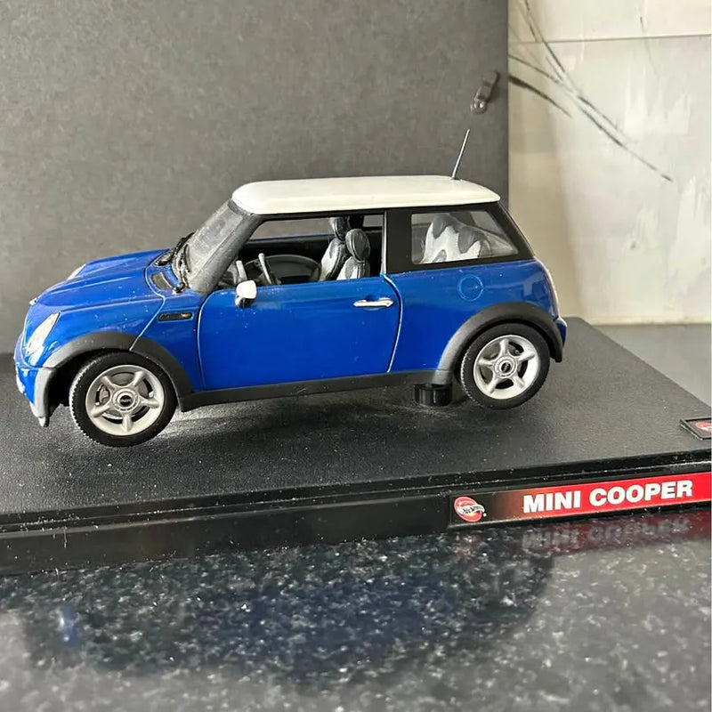 Blue mini cooper diecast car, side view, silver wheels, black roof