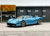 Ice blue racing sports diecast model car, front three-quarter view, gold wheels