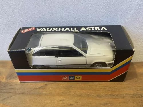 Die-cast model car in retail box with clear window, silver/white car, Vauxhall Astra