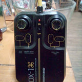 DX-1 remote controller with dual joysticks, ON/OFF switches, and control buttons