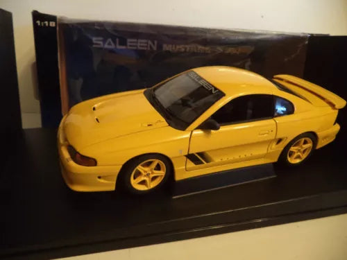 Yellow diecast model car with black roof in retail display box