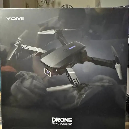 Quadcopter drone on retail box, foldable arms and four propellers