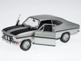 Silver diecast rally coupe model car with open hood and detailed front grille
