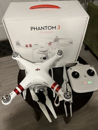 DJI Phantom 3 Standard quadcopter drone with white body, red striped arms, and remote controller