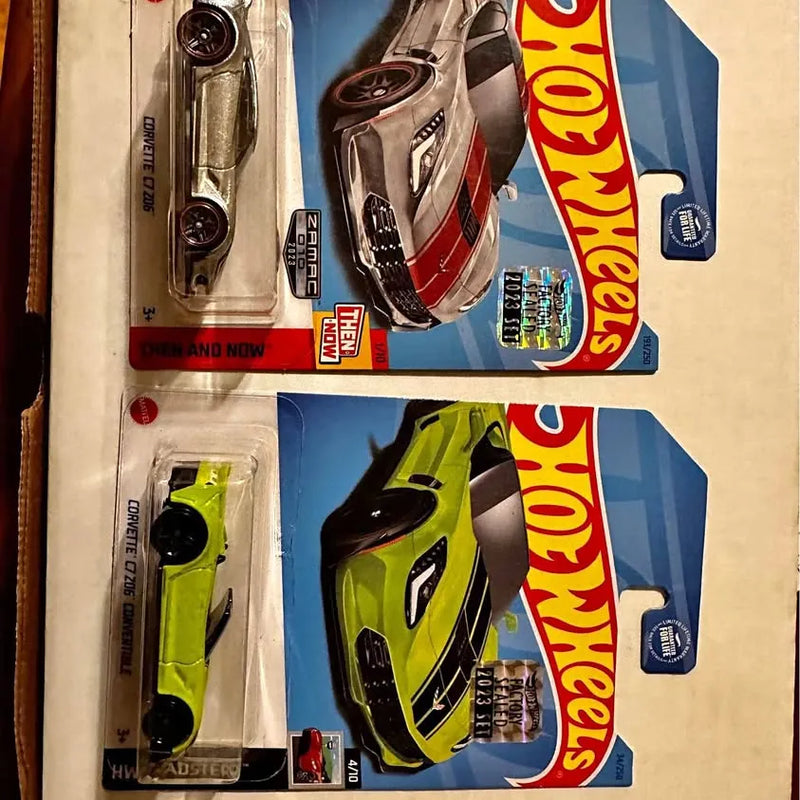 Diecast car blister pack with metallic silver and lime green racing cars