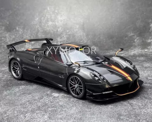 1:18 diecast roadster car model in black with orange accents, front three-quarter view