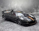 1:18 diecast roadster car model in black with orange accents, front three-quarter view