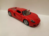 Red Kinsmart diecast toy car, 1/36 scale, with open doors