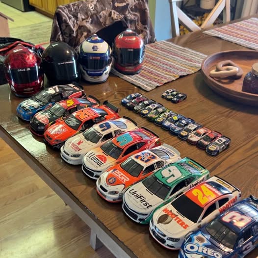 Assorted NASCAR diecast race cars with colorful liveries, models on tabletop