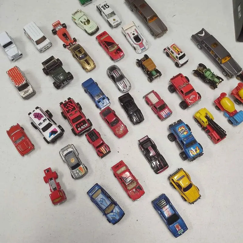 Diecast toy car lot assortment with various colors and designs, shown in a lot
