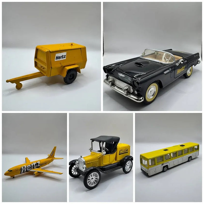 Diecast vehicle lot: yellow trailer, black car, yellow plane, shuttle bus, pickup