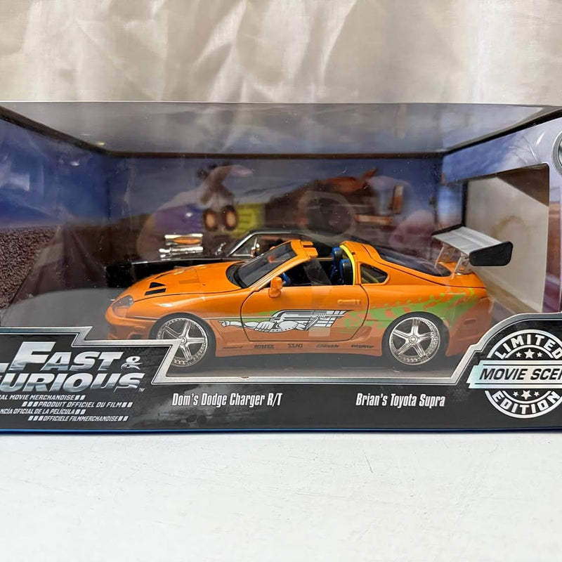 Orange diecast Dodge Charger R/T and Toyota Supra cars in display case