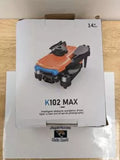 Orange obstacle-avoidance drone with black prop guards, shown in retail box