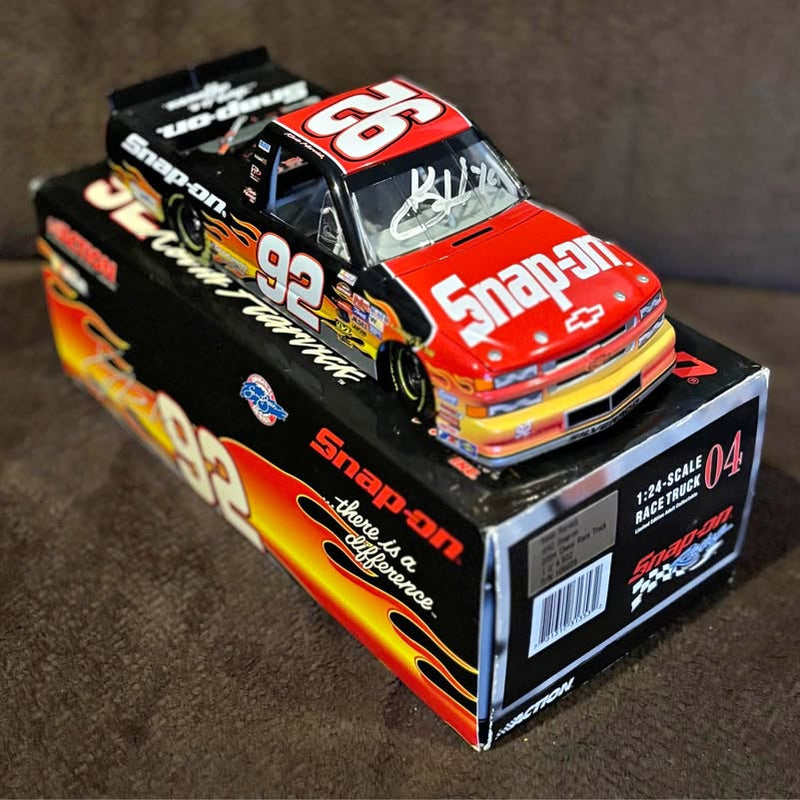 1/24 scale diecast race car in red and black with Snap-on graphics, on display box