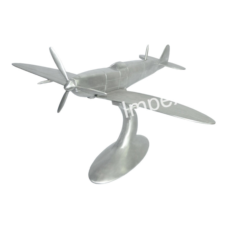 Silver airplane model with propeller, wings, and tail fin—decorative desk display