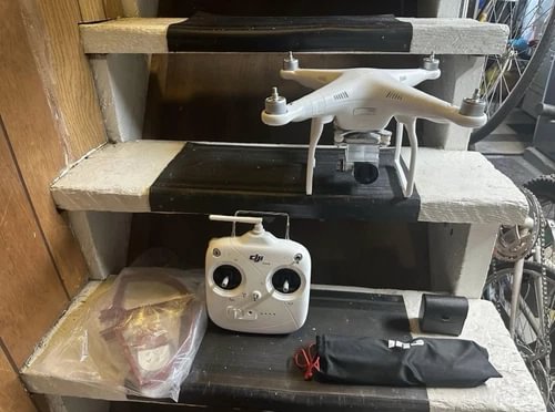 White quadcopter drone with remote controller
