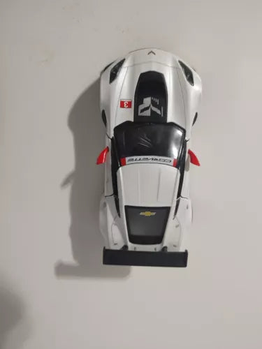 White diecast pull-back race car with black hood and front bumper, top view.
