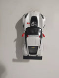 White diecast pull-back race car with black hood and front bumper, top view.