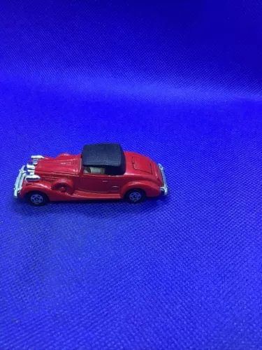 Red diecast coupe roadster with black convertible top, detailed wheels and front grille