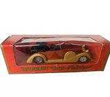 Diecast car model in red Matchbox display box, vintage roadster with tan body