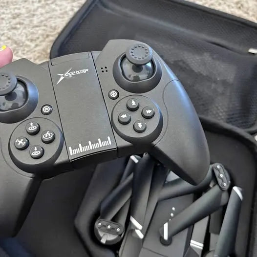 Drone remote controller with twin joysticks, buttons, and textured hand grips