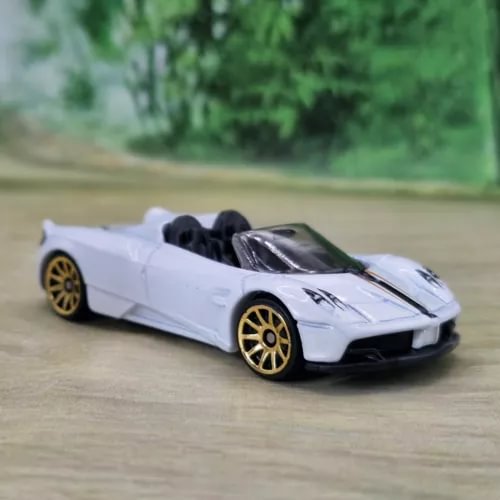 White diecast model car with gold rims and black rear engine detail