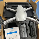 White quadcopter drone with camera and propellers in open box