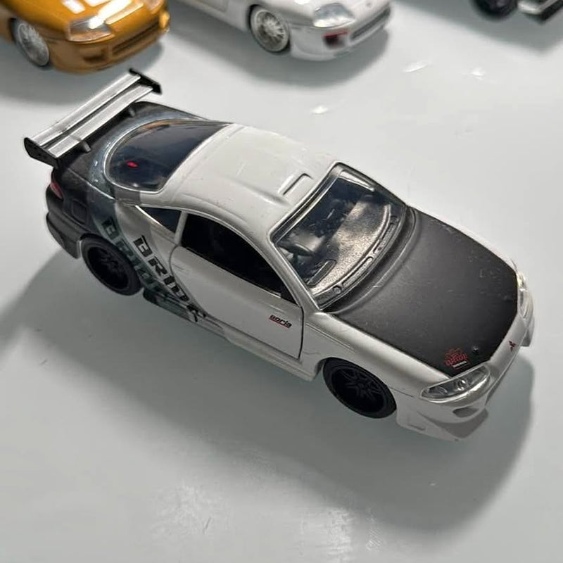 Diecast sports car, silver body with black roof and rear spoiler, open wheels