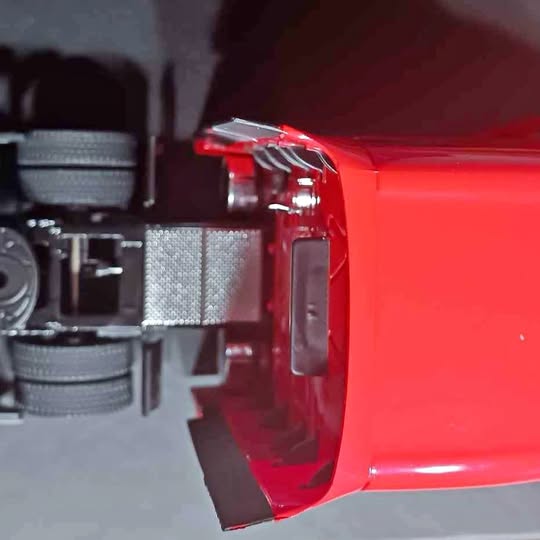 Red diecast sleeper cab truck tractor model, chrome side detail and window