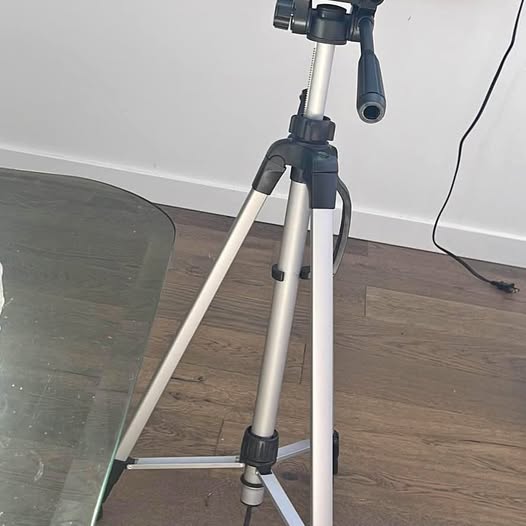 Lightweight tripod with black mounting head and silver three legs