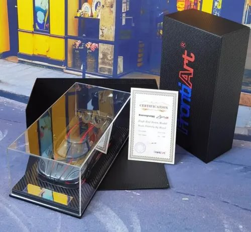 Diecast sports car model in display case with certificate and presentation box