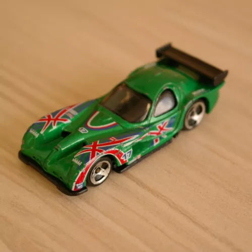 Green racing diecast car with white-red graphics and black rear wing