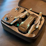 Tan FPV drone with controller and spare parts in hard case