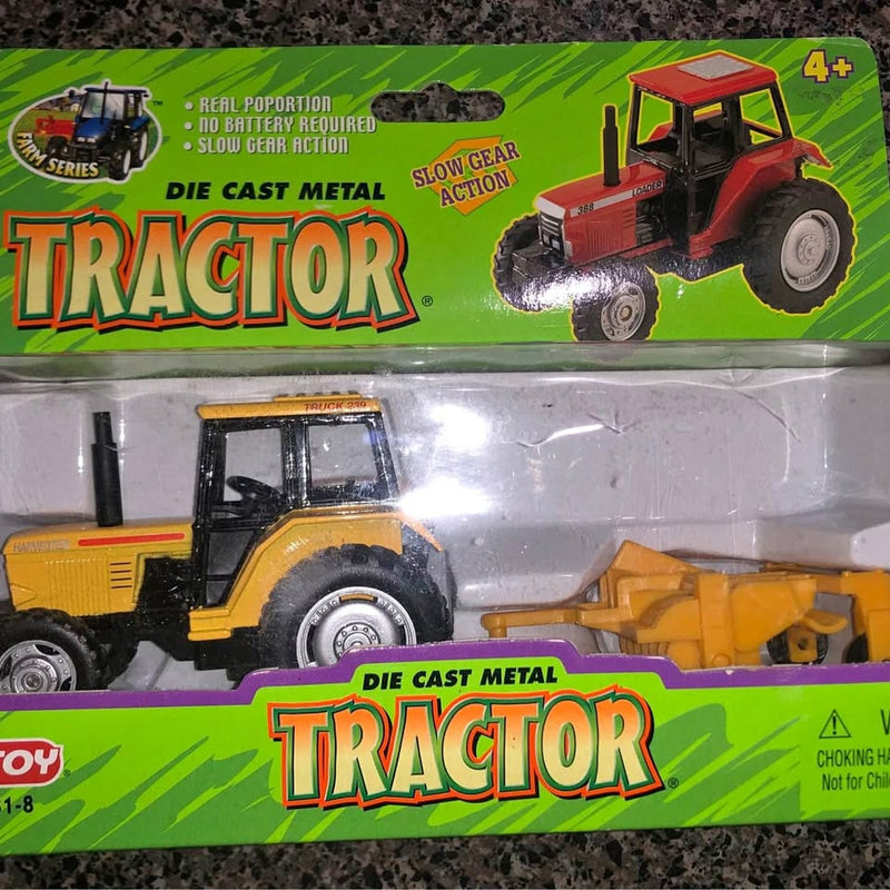 Yellow die-cast tractor with trailer, front view, detailed wheels and cab