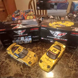 1/18 scale yellow diecast stock car with sponsor decals, shown boxed with two cars