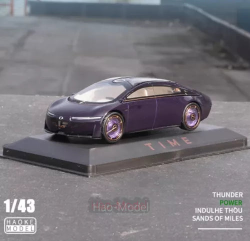 Purple 1:43 diecast model coupe car with alloy wheels on display base