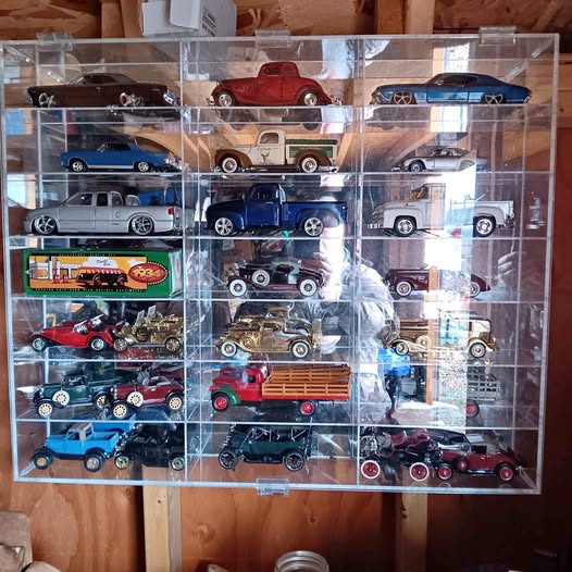 Diecast car display case with assorted cars and trucks