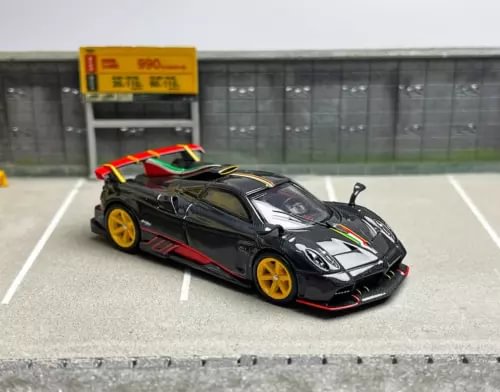 Black race diecast sports car model with white stripes, red accents, yellow wheels