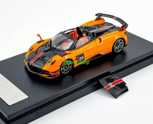 Orange 1:64 sports roadster diecast model with black detailing and rear wing on base.